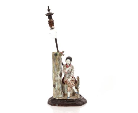 A Japanese porcelain figural table lamp, raised on a hardwood base, 55cm high overall 