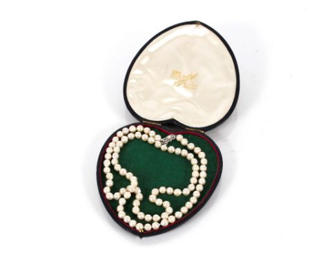 A long string of vintage Baroque pearls, secured by a 14ct white gold clasp, 78cm long (boxed)