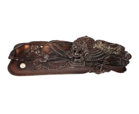 An unusual Japanese spelter pen tray,&nbsp;having warrior and foliate scroll decoration inset with a compass, 27cm&nbsp;