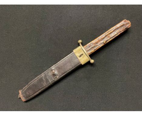 A Bowie knife with single edged blade 180mm in length, maker marked "Joseph Rodgers, Sheffield". Brass crossguard. Horn grips