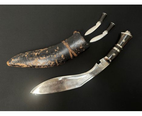 Kukri Knife with plated single edged blade wth some punch mark decoration, 300mm in length. Horn grip. Lions head mask to pom