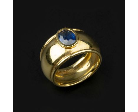 A single stone sapphire ring, the oval cut sapphire, estimated to weigh 1.20 carats, on a wide polished band, stamped 750, fi