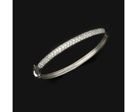 A diamond bangle, the hinged bangle half set with brilliant cut diamonds, approximately 2.10 carats total, stamped 750 with f