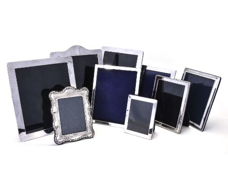 Nine English silver photograph frames, comprising: five plain by Theo Fennell, London 1997, black leather covered easel backs