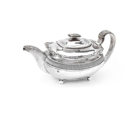 ϒ A late George III silver oblong baluster tea pot, maker's mark worn (..H), London 1815, with a lobed rectangular button fin