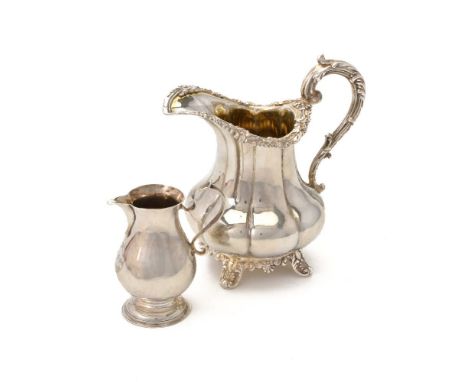A George IV English provincial silver lobed baluster cream jug by John Walton, Newcastle date worn, with a leaf-capped moulde