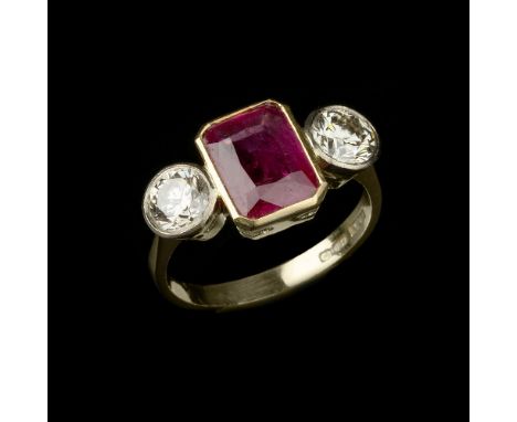 A ruby and diamond ring, the central rectangular cut ruby, collet set between two brilliant cut diamonds, approximately 1.20 