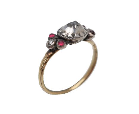 An antique diamond and garnet ring, the two table cut diamonds in a raised silver setting, between the shoulders set with ros