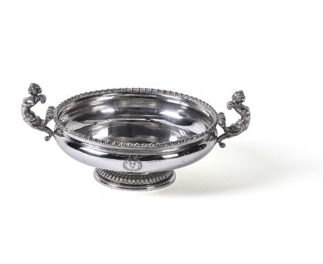 A silver twin handled footed bowl by Wakely &amp; Wheeler, London 1910, with twin caryatid flying scroll handles, an egg-and-