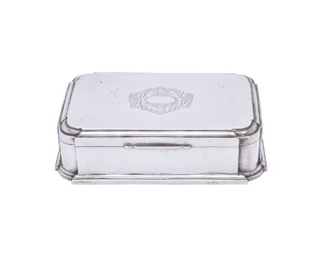 A silver jewellery box by William Comyns &amp; Sons, London 1913, rectangular with inset curved angles, engraved with a vacan