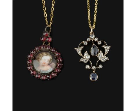 An early 20th century diamond and sapphire pendant, the scrolled gold backed silver foliate pendant set with rose cut diamond