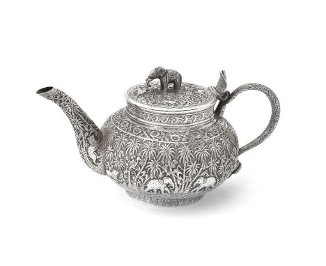 An Indian silver compressed spherical tea pot, unmarked, circa 1900, with an elephant finial to the almost flat cover, a serp