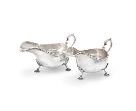 A pair of silver oval sauce boats by Martin, Hall &amp; Co., Sheffield 1928, with gadrooned rims, tongue-capped double scroll