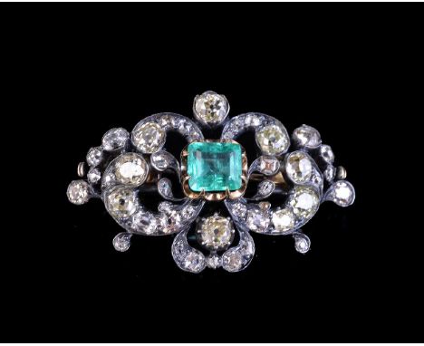 A mid Victorian yellow diamond, diamond and emerald brooch, circa 1870, the gold backed silver pierced scrolled setting with 