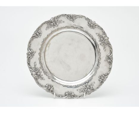 A German silver shaped circular plate by Georg Roth &amp; Co., Hanau 1891- c. 1919, the scroll rim with flowers and foliage, 