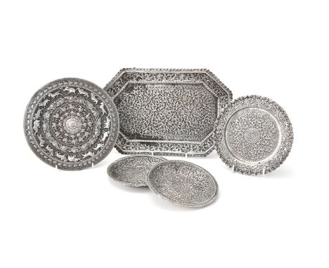 Five Indian silver plates, dishes or trays, unmarked, circa 1900, comprising: a canted rectangular tray, 30.5cm (12in) long; 