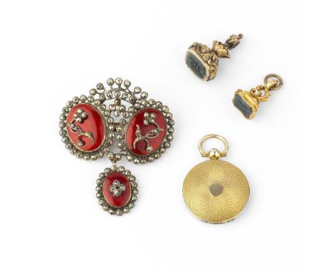 A late Victorian gold locket, circa 1900, the circular panelled locket with engine turned decoration, opening to reveal a gla