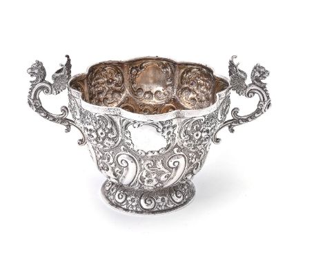 A late Victorian silver multi lobed twin handled bowl by Wakely &amp; Wheeler, London 1890, with winged dragon-capped scroll 