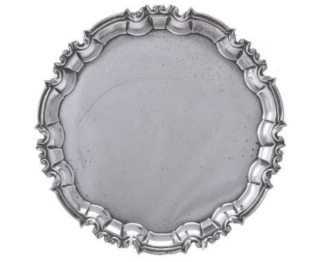 A silver shaped circular salver by William Hutton &amp; Sons, Sheffield 1937, on three scroll feet, 26cm (10in) diameter, 617