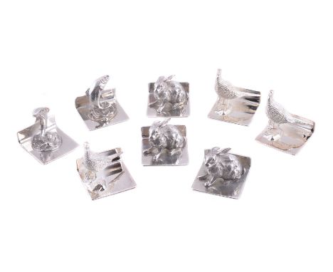 A set of eight silver menu or name card holders by Whitehill Silver &amp; Plate Co., Birmingham 2001, with cast animals: thre