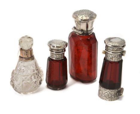 Three various mounted glass scent bottles, one facetted ruby glass binocular double ended, unmarked, 12.8cm (5in) long; facet