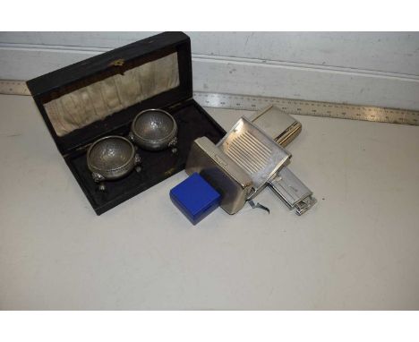 A cased pair of pewter salts together with a cigarette lighter, cigarette rolling machine, tobacco boxes etc