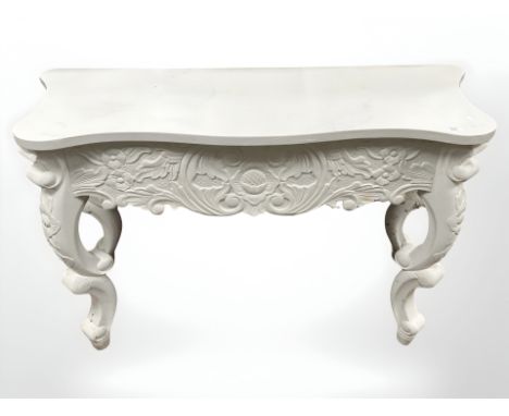A contemporary carved painted console table on cabriole legs, 132 cm x 78 cm x 52 cm.