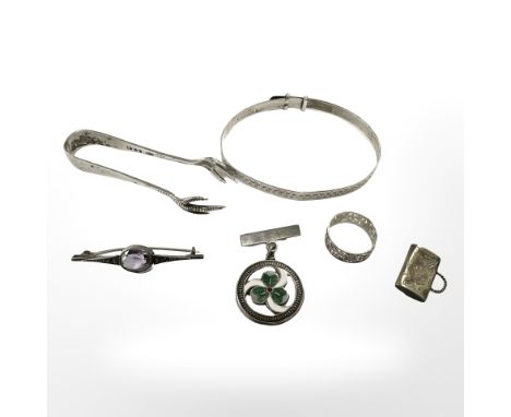 A small group of silver items to include sugar tongs, enamelled brooch, charm, brooch, ring and bangle. CONDITION REPORT: 36.