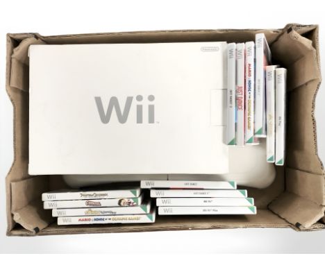 A Nintendo Wii console, Wii Fit board, controllers and various games. (1 box)