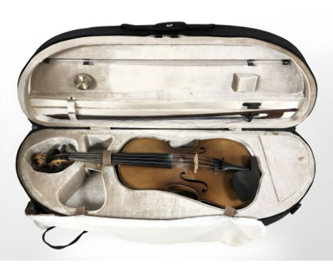 A copy of a Stradivarius violin made in West Germany, labelled to interior, with one piece 14" back, with bow, in carry case 