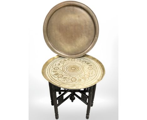 An Eastern bobbin turned brass toped table and further copper shallow dish 