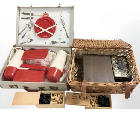 A picnic hamper and a luggage case containing Staunton chess sets, etc. 