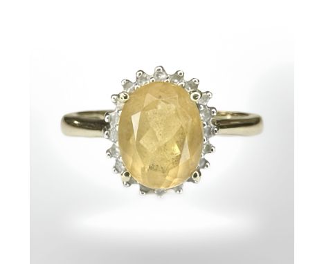 A 9ct yellow gold cluster ring set with a synthetic yellow stone, size N/O. CONDITION REPORT: 2.9g.