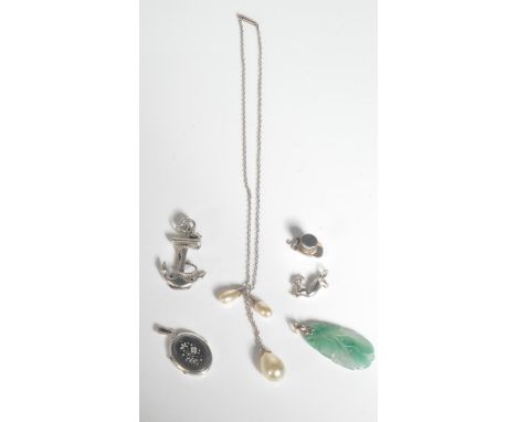 A Chinese jade pendant with silver bale together with a silver 925 anchor and rope pendant with bale, silver chase decorated 