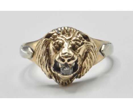 A 9ct gold lions head mask ring. The ring with large lions head mount adorned with Cz stone to the mouth. Hallmarked Birmingh