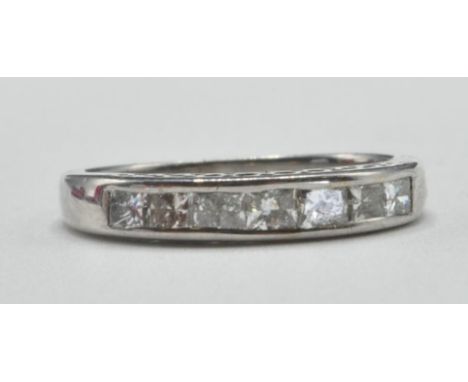 An 18ct white gold half eternity ring channel set with sven square cut diamonds. Band marked 18k. Weight 3.6g. Size N.