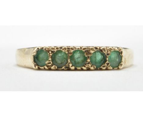 A hallmarked 9ct gold ring set with five round cut green stones. Hallmarked London 1981. Weight 1.8g. Size Q.