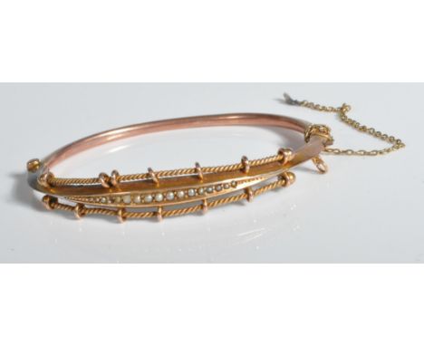 A 19th Century Victorian bangle bracelet being set with seed pearls with rope twist borders and a tongue in groove clasp, saf