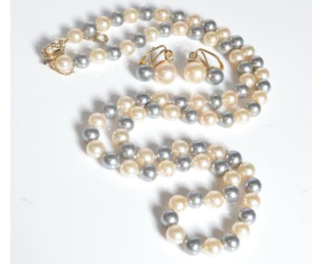 A cultured pearl demi parure jewellery set to include necklace and earrings, the necklace having alternate white and grey pea