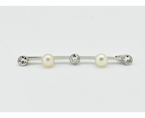 A French platinum, diamond and pearl bar brooch. The brooch set with three old cut diamonds and 2 cultured pearls. Principle 