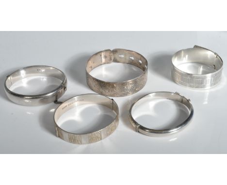 A collection of 5 hallmarked bangles. To include Birmingham hallmarked chase decorated examples, Chester hallmarked buckle ex