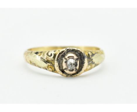 A hallmarked George III 18ct gold and diamond ring. The ring set with an old cut diamond within a gold collet setting flanked