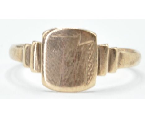 A stamped 9ct gold ring having geometric decoration to the shoulders. Bearing stamps for MMM, 9ct. Ring size O. Gross weight 