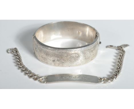 A hallmarked silver bangle bracelet with chased decoration (hallmarked Birmingham 1959) together with a hallmarked curb link 