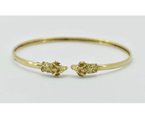 An antique revival 14ct gold double rams head bangle. Each end with rams head finials, Stamped 14k / 585. Total weight 8.03 /