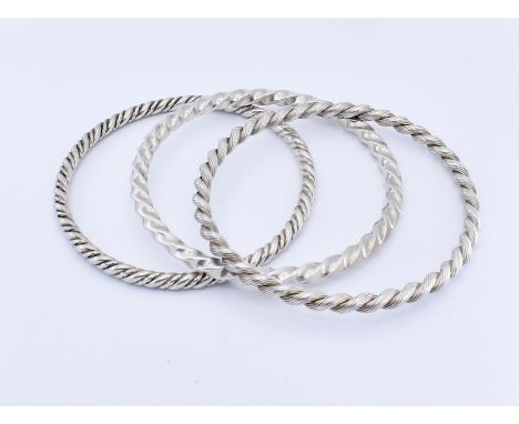 Wolfers - Three mid century silver bangles. The bangle of multiple twist designs.&nbsp; Marks for silver and maker Wolfers. T