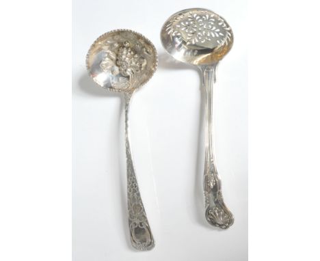 Two antique hallmarked sterling silver spoons comprising of a tea strainer spoon having palmette embellishments with floral p