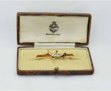 A case gold and diamond bar brooch pin. The brooch formed of triple knife bar with diamond set crescent motif having diamond 