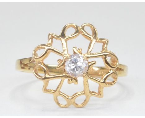 A 9ct gold hallmarked cut out ring with central white round brilliant cut cz stone&nbsp; within pierced cut out halo to plain