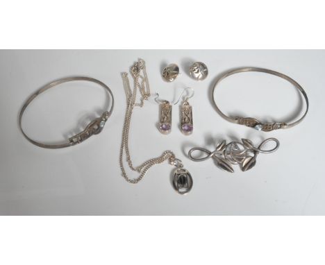 A group of silver Rennie Mackintosh style jewellery to include a pair of drop earrings set with round cut purple stones, a pe